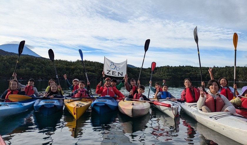 Participants gather for a group photo in their kayaks