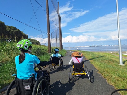 Scene of riding handbikes along the coast